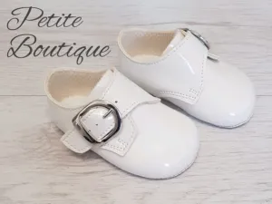 White patent buckle over soft sole shoes