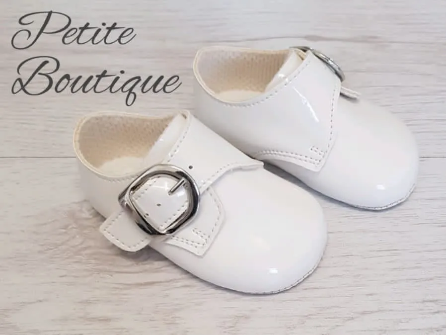 White patent buckle over soft sole shoes